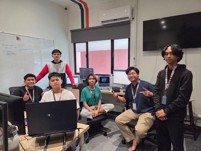 Dev team with laptops in office