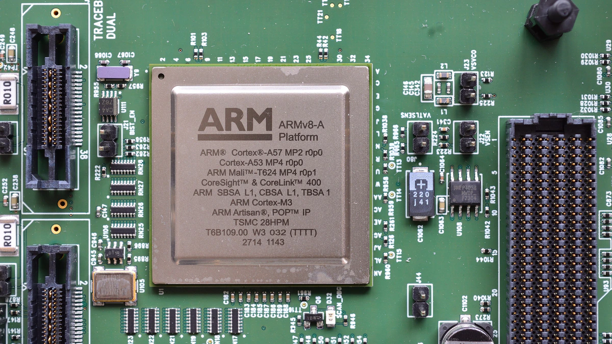 A square silver Arm chip marked ARMv8-A Platform, Cortex-A57, Cortex-A53 and Mali-T624, soldered to a green circuit board between rows of connectors and small components
