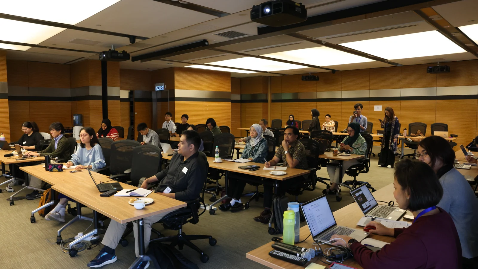 Participants working together at a Bank Negara Malaysia financial innovation workshop