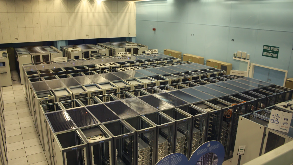 Rows of server racks in a data centre seen from a raised walkway, with signs for mail servers and web servers