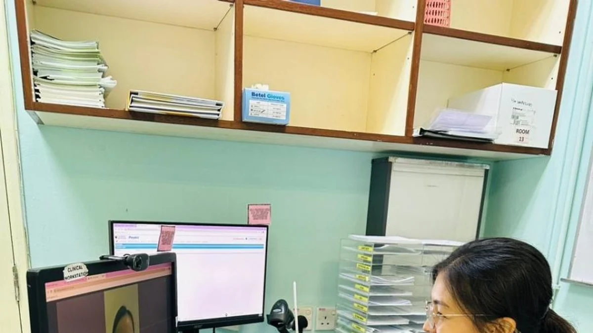 A Universiti Malaya clinician conducts a teleconsultation with a patient on a clinic computer