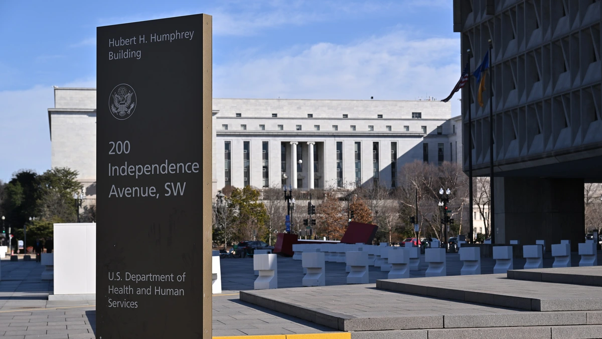Dark information sign for the Hubert H. Humphrey Building, 200 Independence Avenue SW, Washington, with the large federal building behind it
