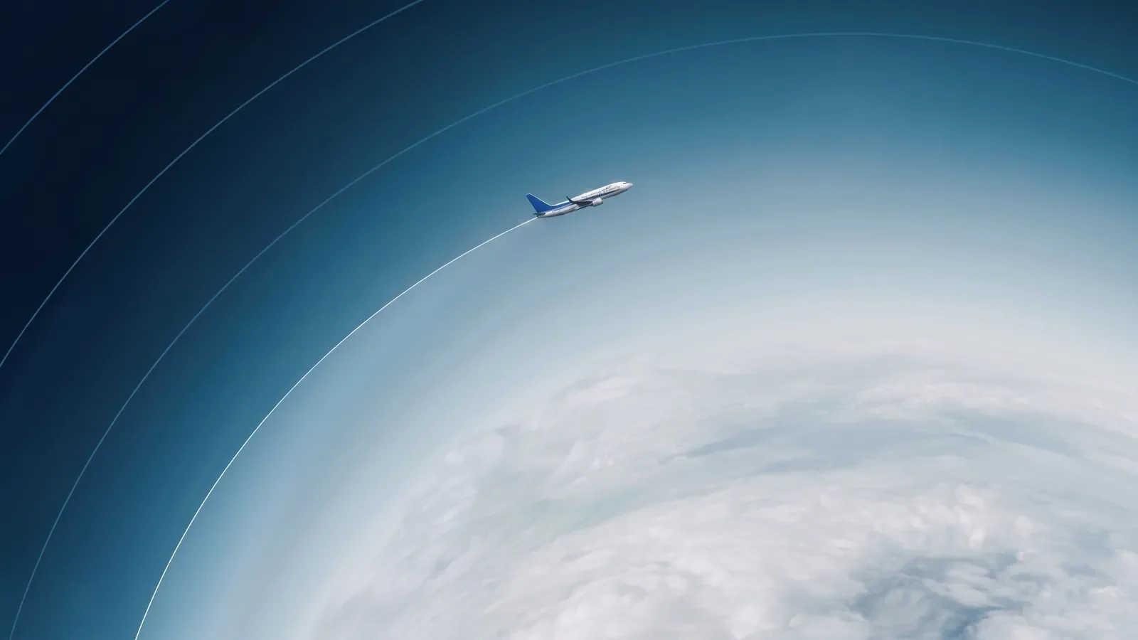 Commercial aircraft flies above clouds while leaving a persistent white contrail