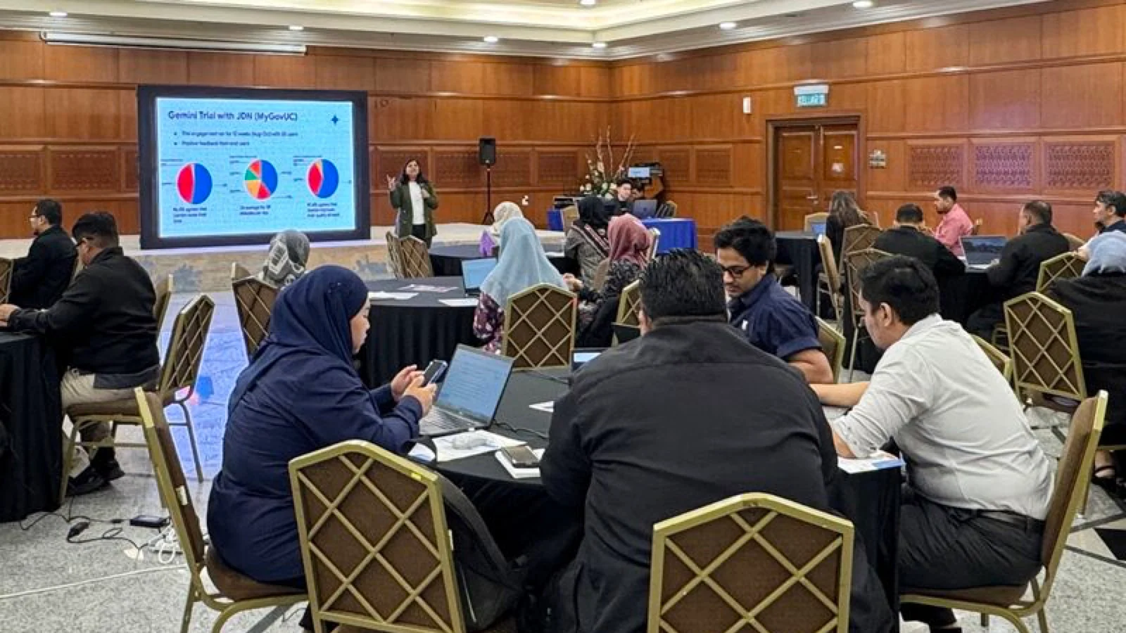 A trainer presents Gemini trial results to Malaysian public officers during the Train-the-Trainer programme