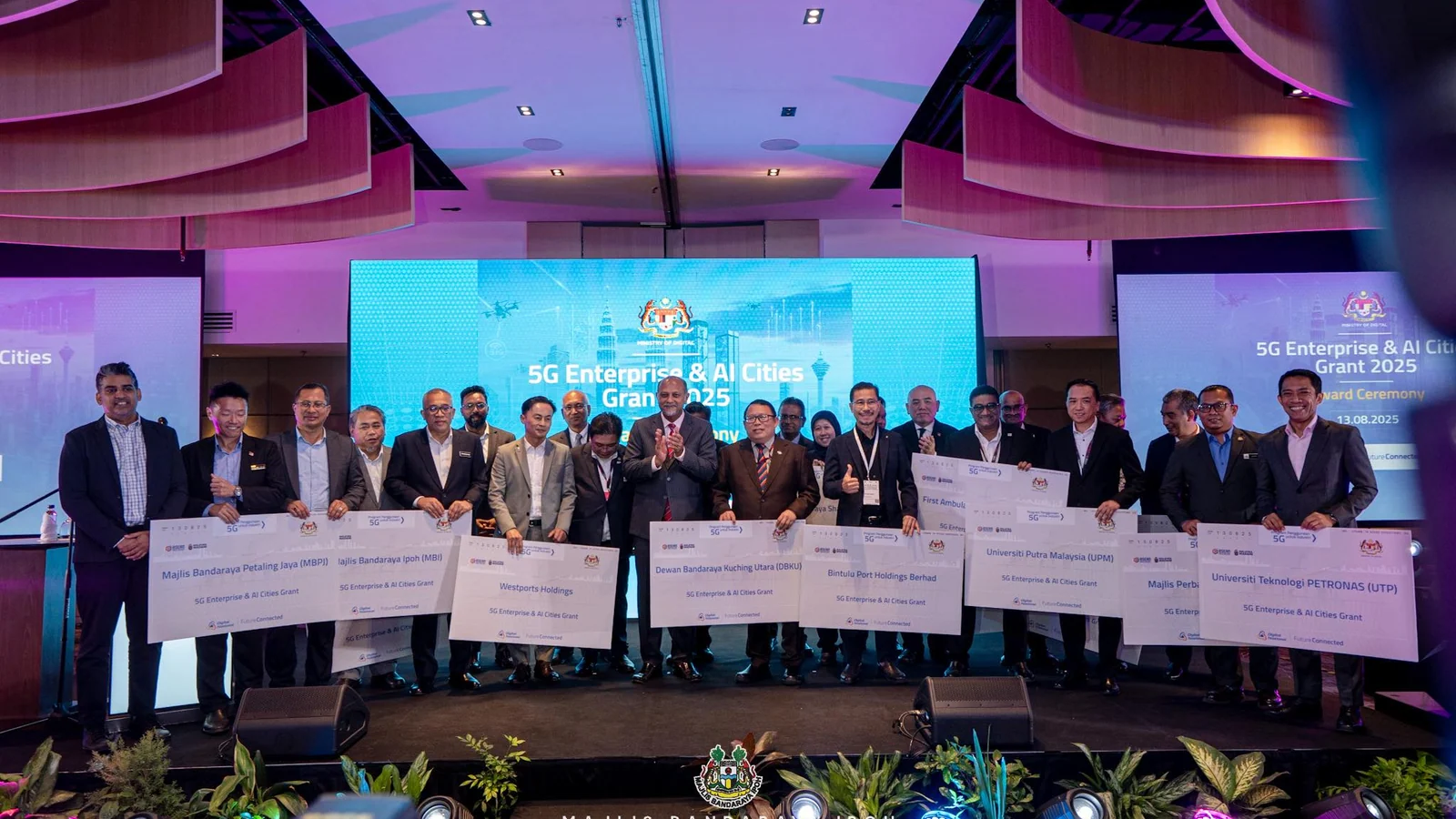 Recipients gather with their 5G Enterprise and AI Cities grant awards at MITEC in Kuala Lumpur