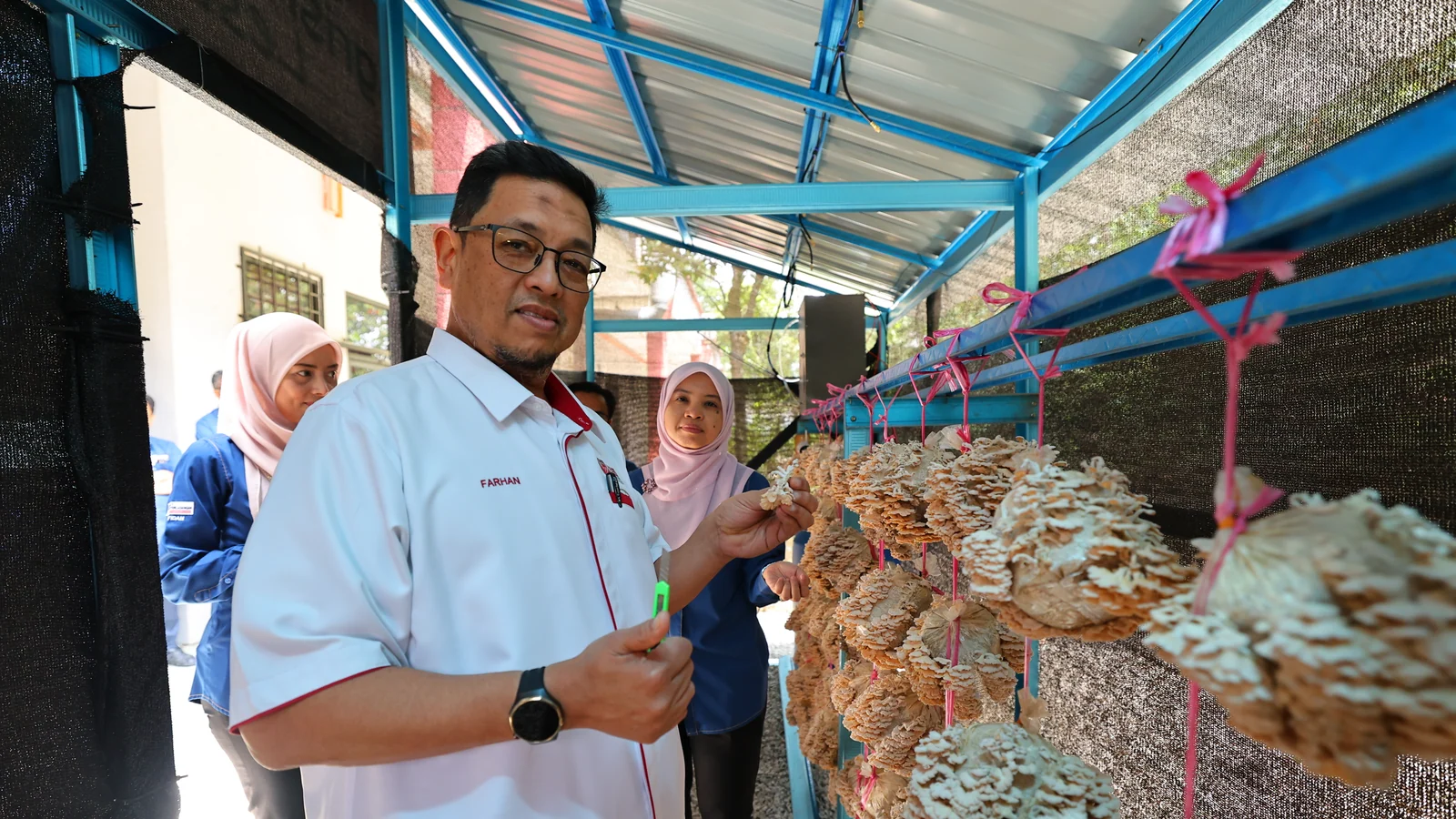 UPM staff inspect mushroom cultivation inside the AgriSMART Lestari greenhouse
