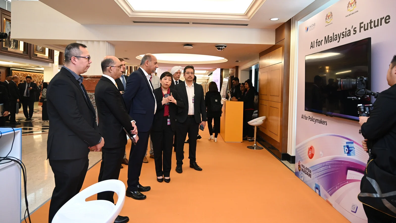 Digital Minister Gobind Singh Deo and officials view an AI for Policymakers demonstration in Parliament