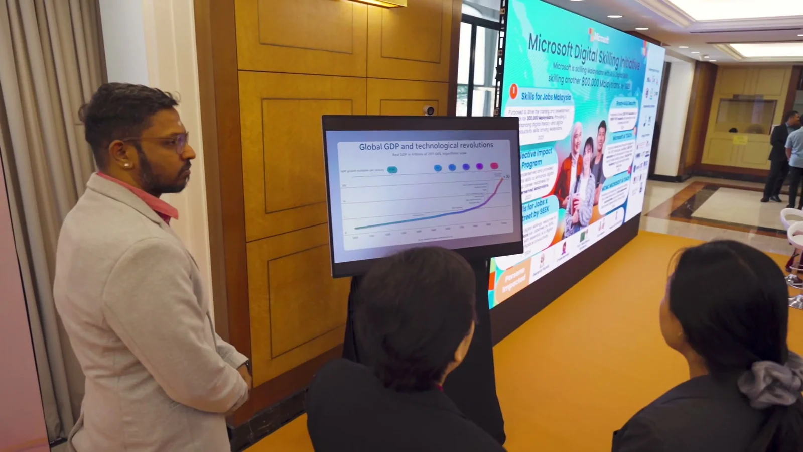 Participants view an AI skilling demonstration at Malaysia's AI for Policymakers showcase