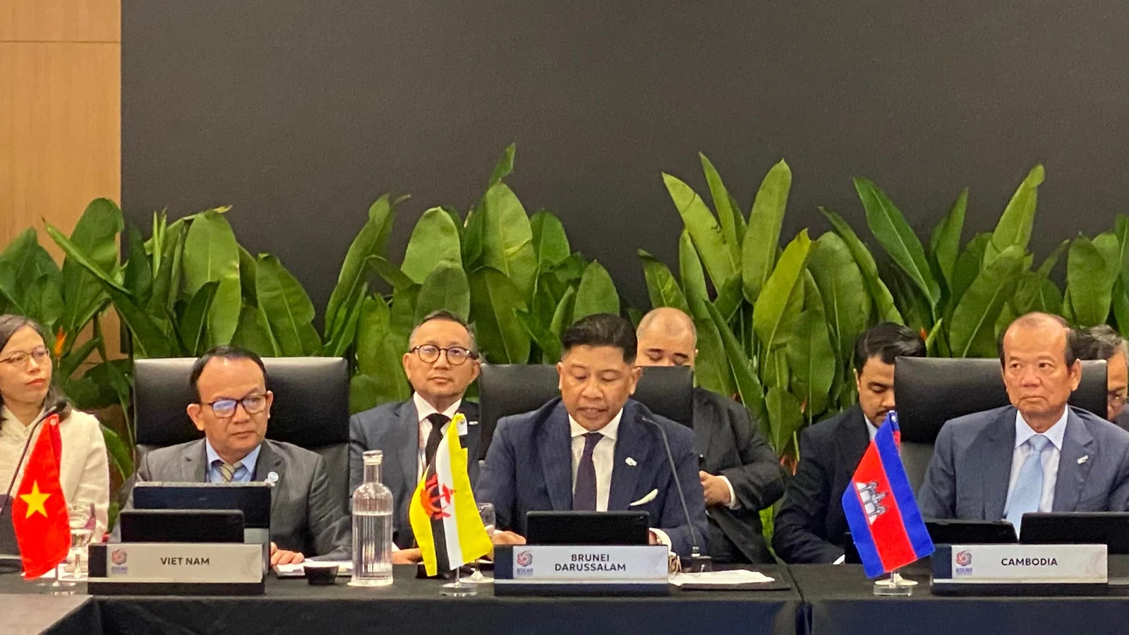 Delegates sit at a conference table during an ASEAN AI Malaysia Summit session