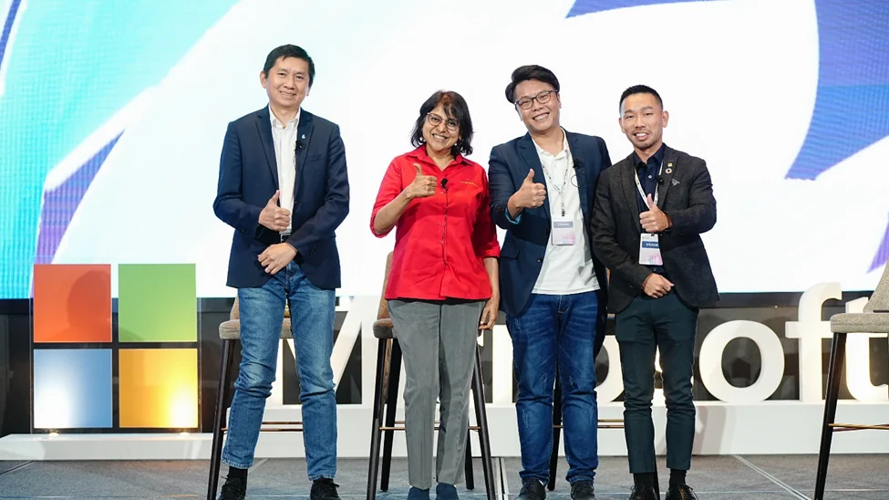 Four Malaysian business speakers stand after a panel at Microsoft AI Summit 2023 in Kuala Lumpur