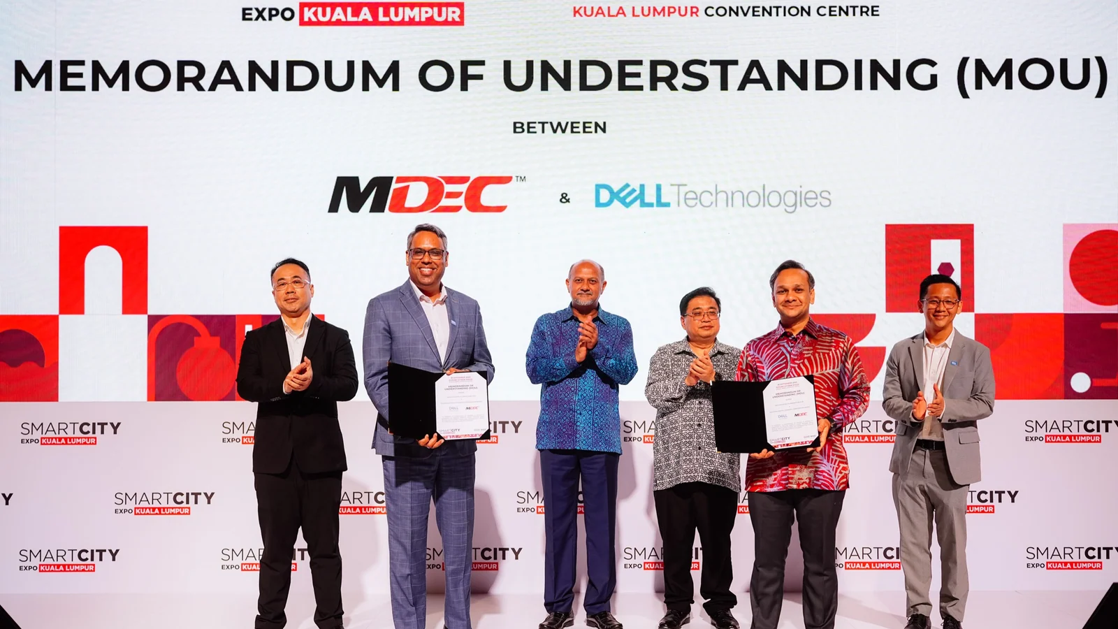 MDEC and Dell Technologies representatives exchange a climate AI testbed memorandum at SCEKL25