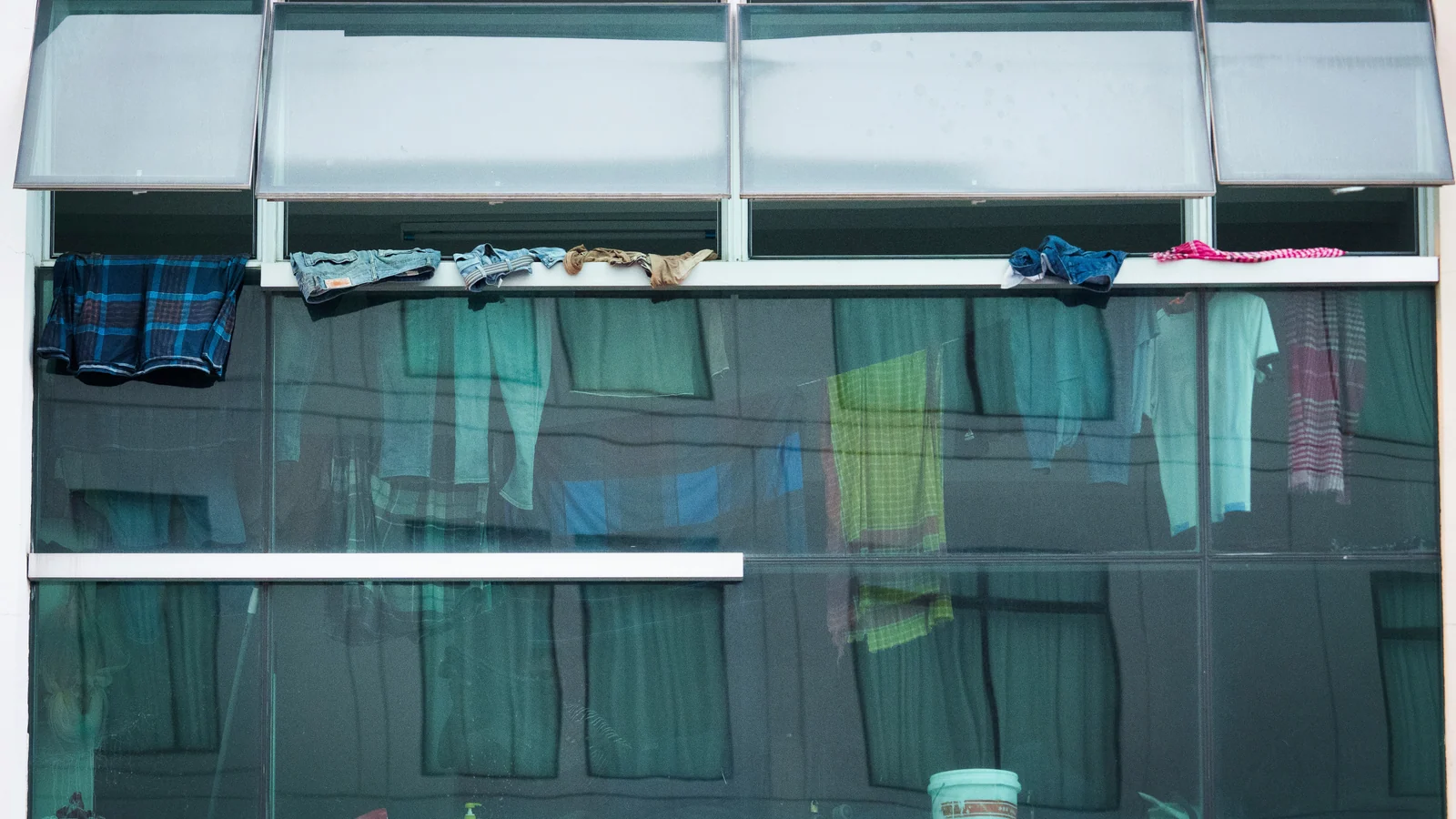 Construction workers' laundry hangs at a shop next to a data centre under construction in Johor Bahru