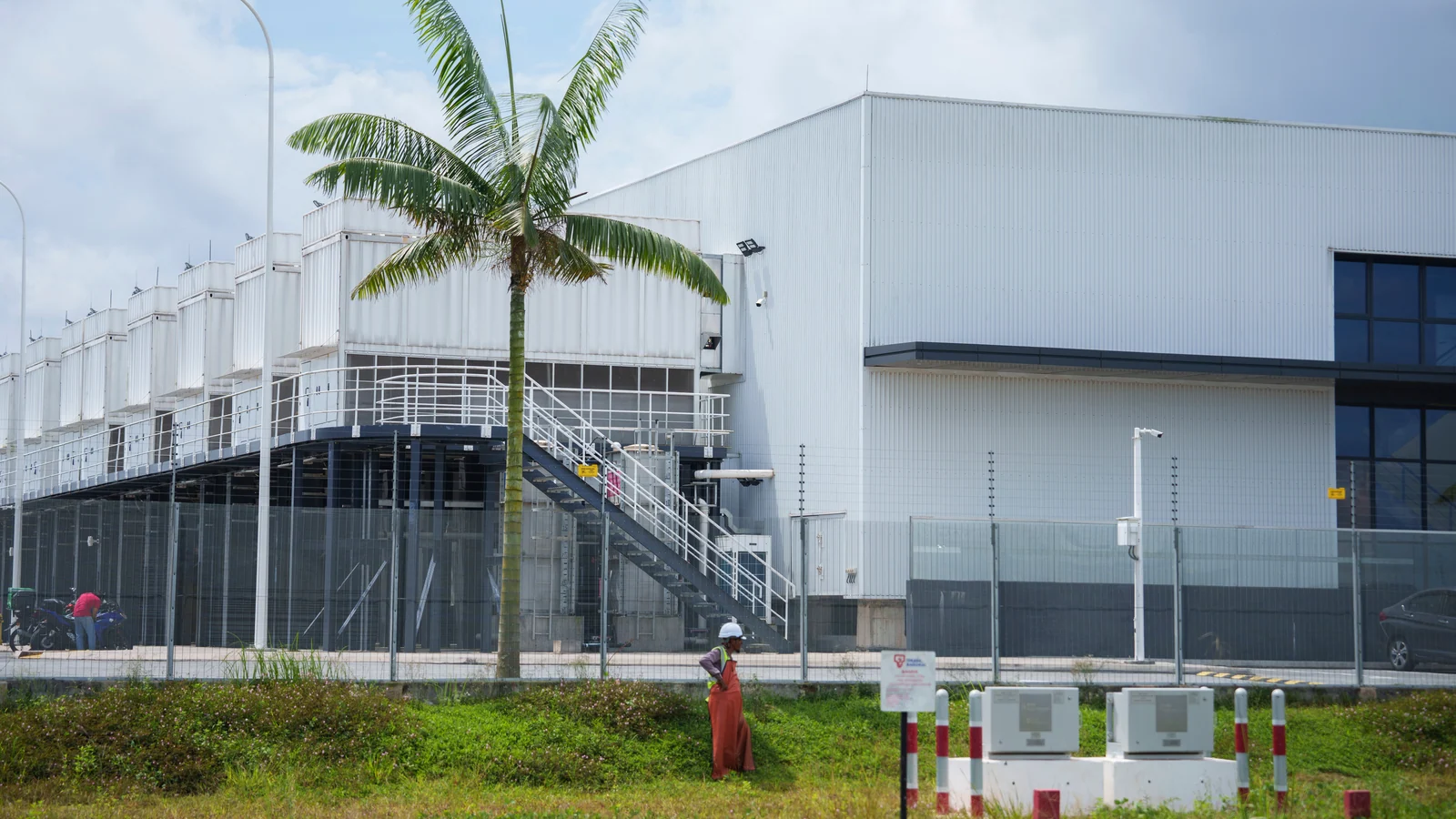 Construction workers stand outside a data centre in Sedenak Tech Park in Johor on 27 September 2024