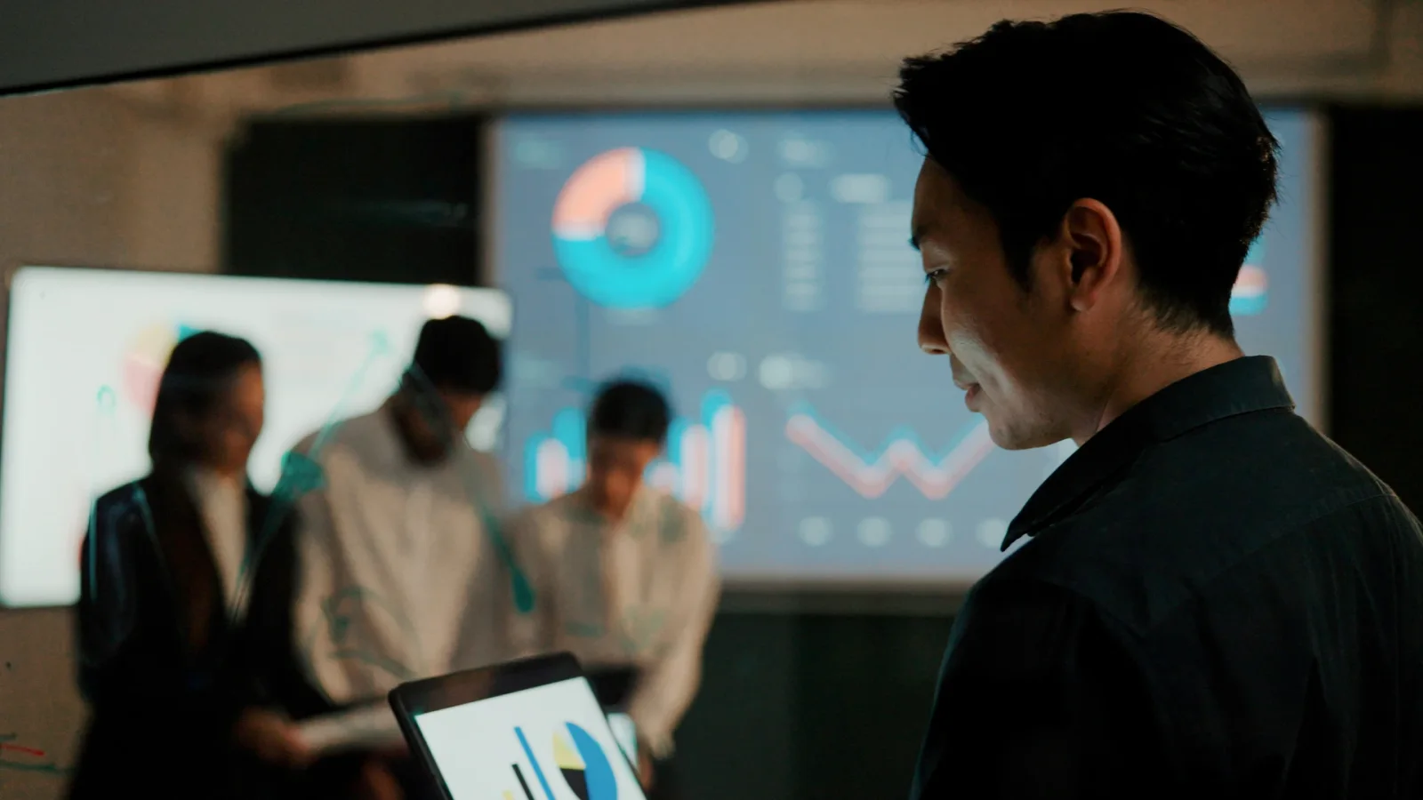 A team reviews business analytics dashboards in an official Microsoft Dynamics photograph