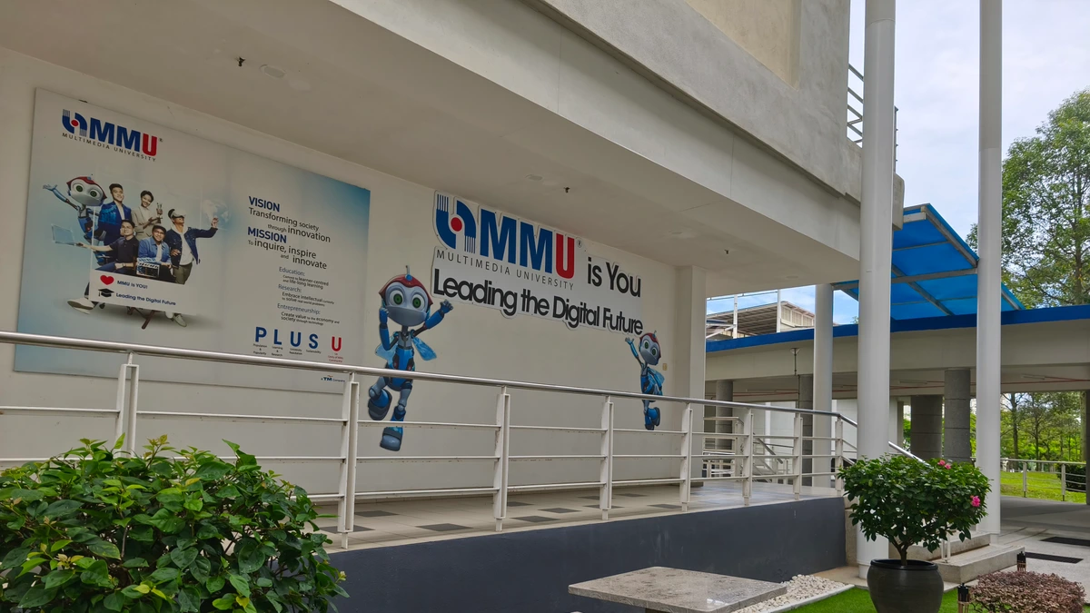 Outdoor student terrace and red-and-blue Multimedia University branding wall at its Cyberjaya campus