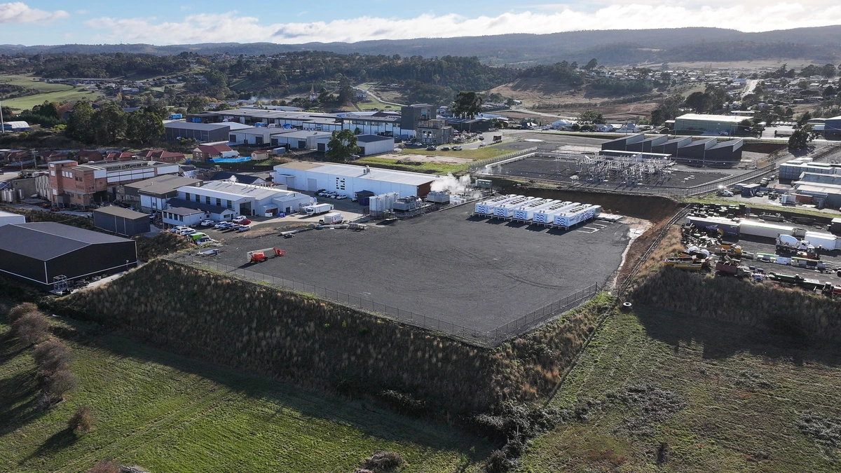 Aerial view of the Project Southgate site in northern Tasmania, showing a cleared development pad beside an industrial estate and an electrical substation