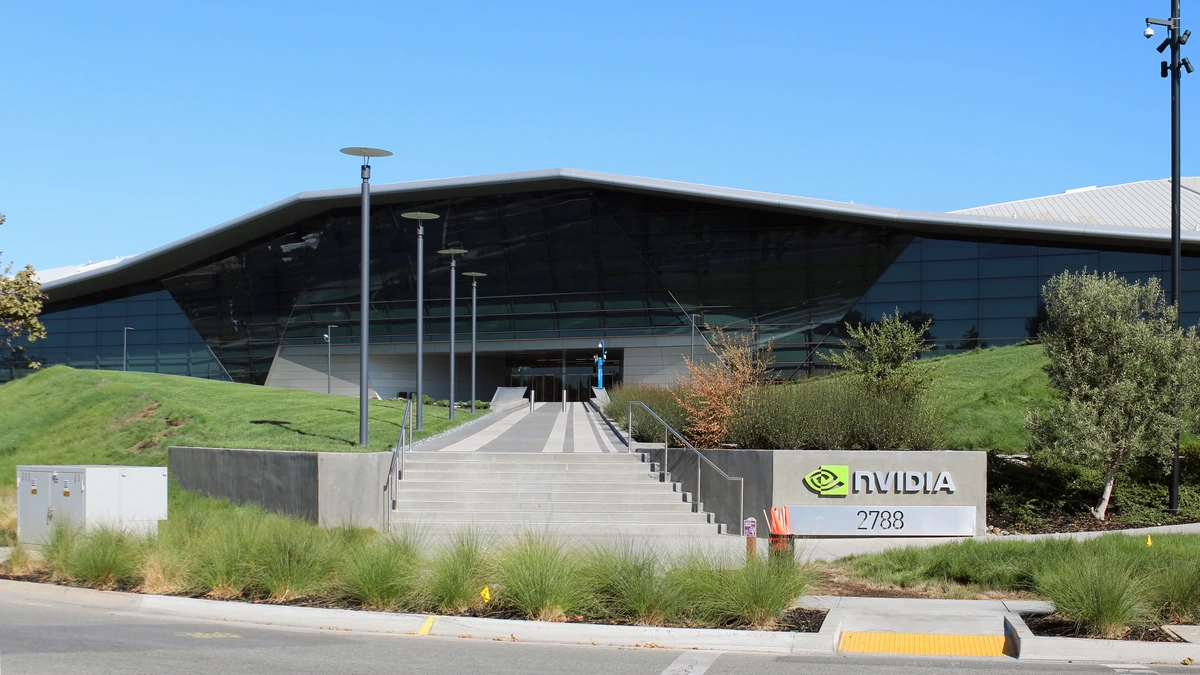 A glass-fronted building with a swooping roof above a grassy slope, a stair path and an NVIDIA sign beside the number 2788