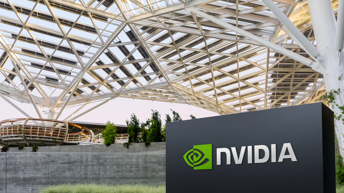 The solar canopy and entrance signage at NVIDIA's Santa Clara campus at dusk, with a dark monolith carrying the NVIDIA logo in the foreground
