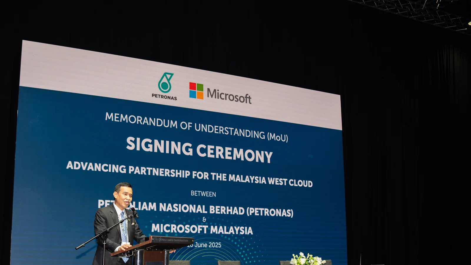 PETRONAS representative speaks at the 2025 Microsoft partnership signing ceremony