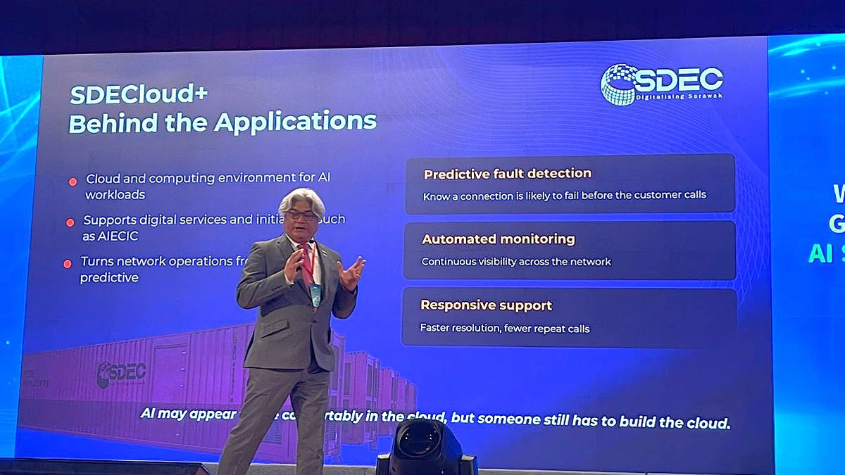 SDEC chief executive Sudarnoto Osman speaking on stage beside a slide about SDEC cloud services