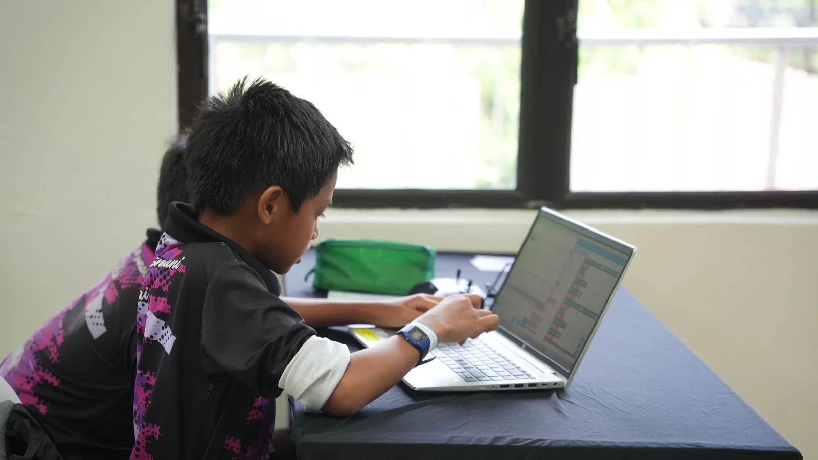 A Southern Zone Techlympics participant works on a block-based coding project at a laptop