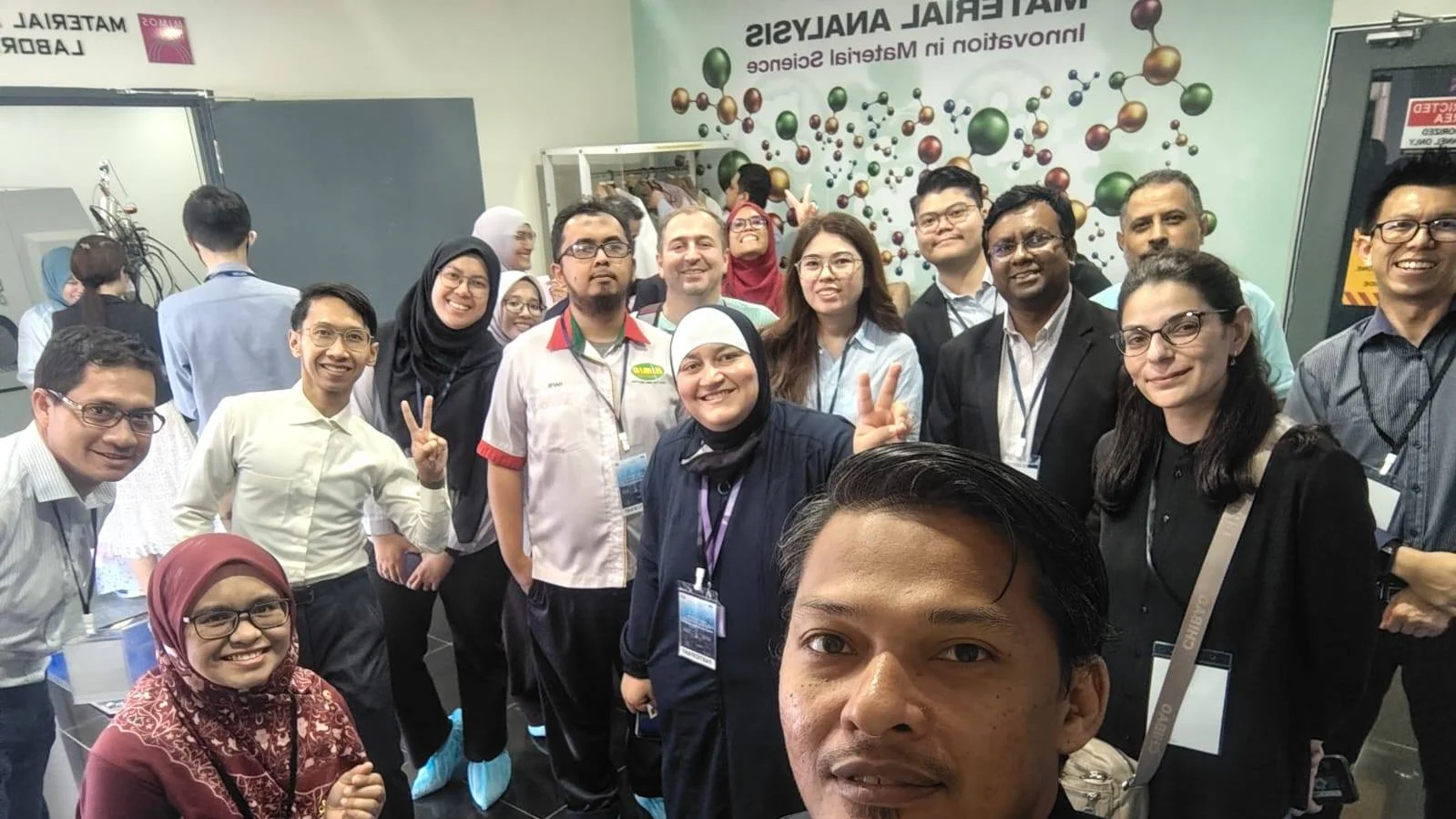 International AI workshop participants gather during a visit to the MIMOS Material Analysis Laboratory