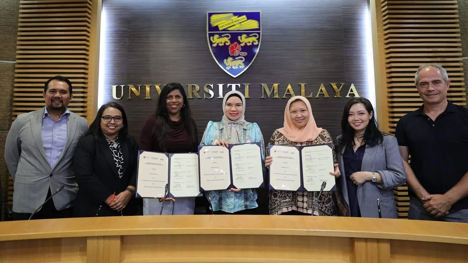 Universiti Malaya, CADS AI and DAMA representatives display signed agreements for the university-wide AI and data literacy programme